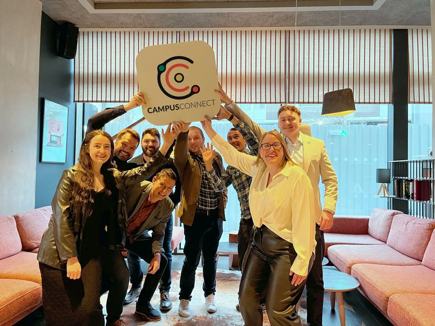 The CampusConnect team holding up a large CampusConnect logo sign
